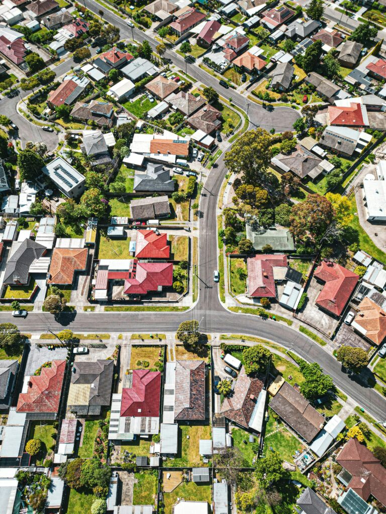 Drone shot of a vibrant Melbourne suburb showcasing houses and streets from above.